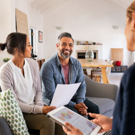 Couple talking to financial advisor at home