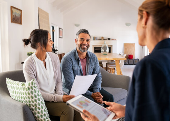 Couple talking to financial advisor at home